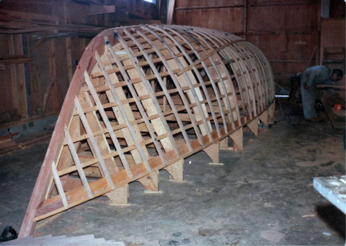 The upturned timber frames of Jura's hull in the boatshop, 1978