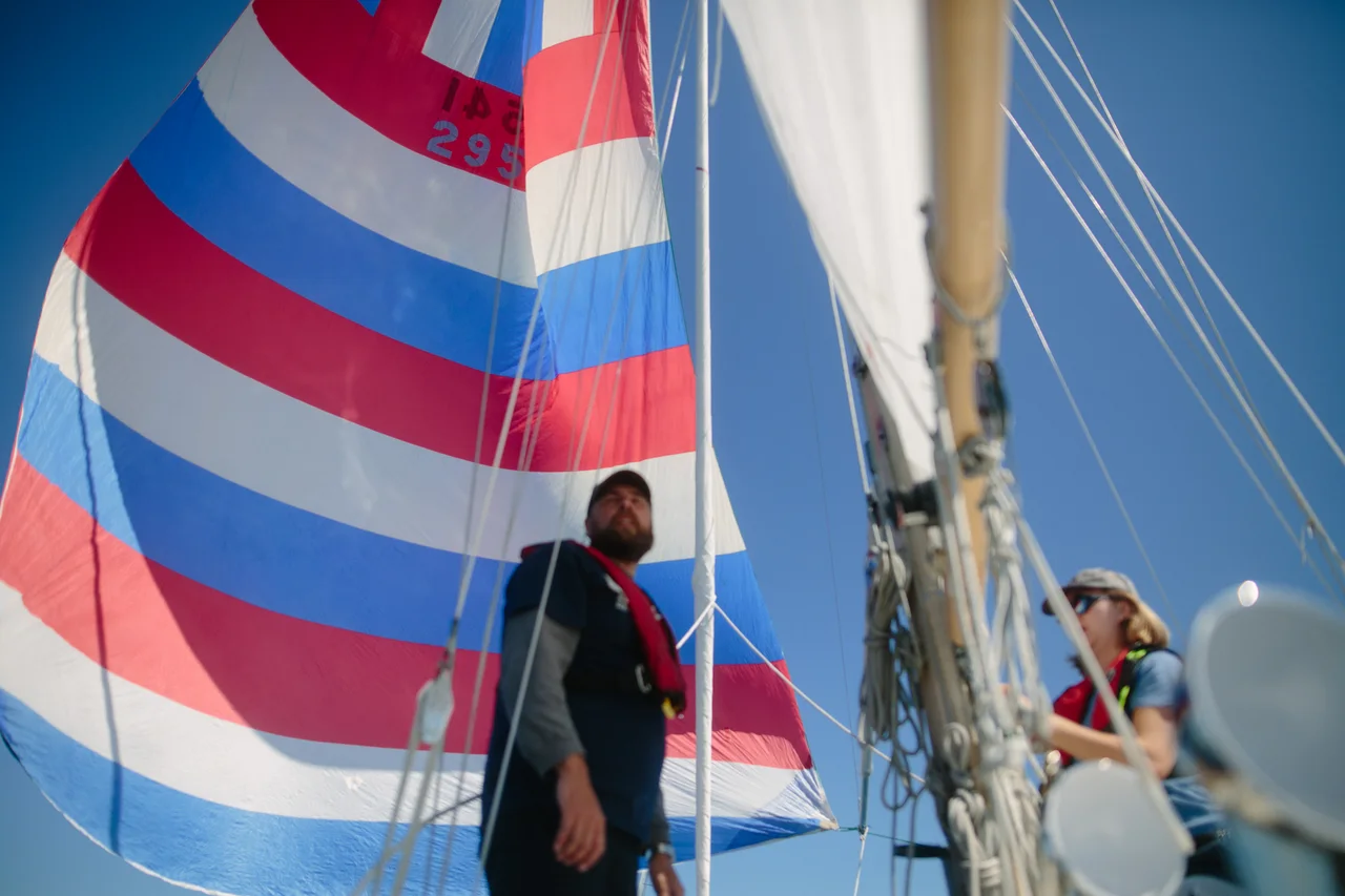 Crew beneath a red, white and blue spinnaker during the Victoria race